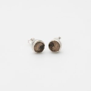 Handcrafted raw smoky topaz stud earrings with grey-brown gemstones set in textured sterling silver. Rustic and organic design with unique stone variations, finished with butterfly backs for secure wear. Perfect for minimalist or boho-inspired styles.